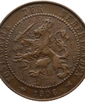 Brown coin with a lion emblem and text 'Koningrijk der Nederlanden' and '1906'.