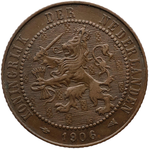 Brown coin with a lion emblem and text 'Koningrijk der Nederlanden' and '1906'.