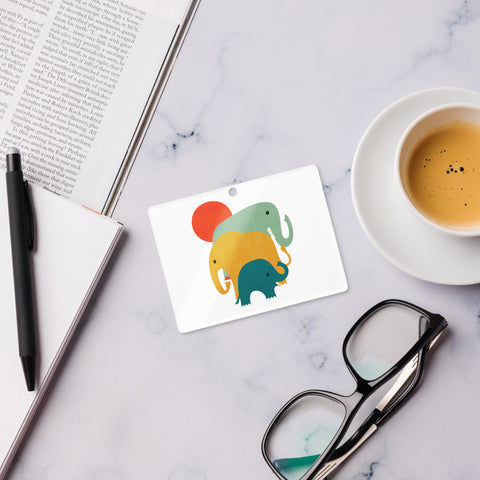 Colourful Elephant Trio rectangular acrylic ornament, green yellow and teal elephants beneath a red sun, red hanging ribbon – view 3