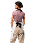 Plain reverse of the white Chicken on a Bicycle kitchen apron, showing black twill ties and fasteners