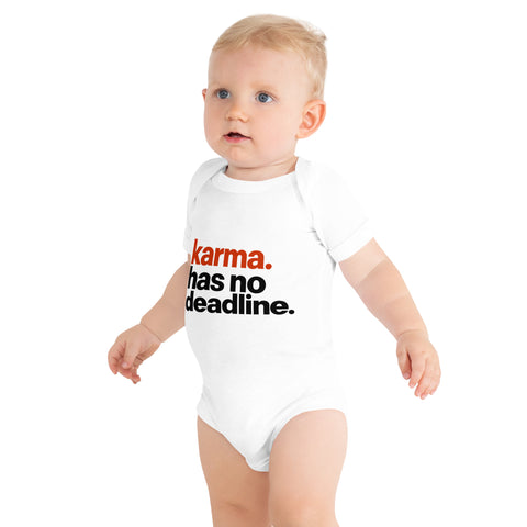 White baby bodysuit with original rust-orange and black Karma Has No Deadline lettering on the front – ZIPZAPPA