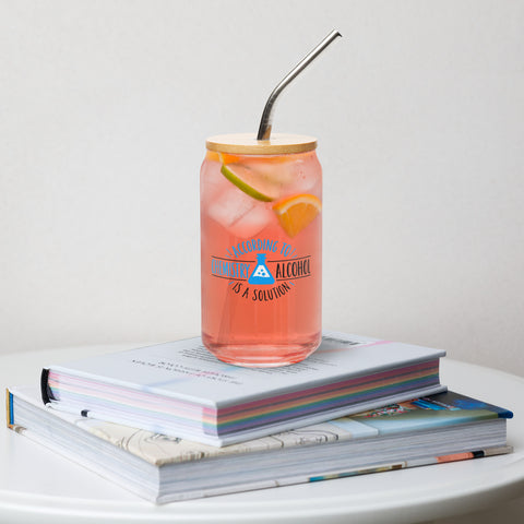 Alcohol Is a Solution 473 ml can-shaped glass with bamboo lid and metal straw, filled with a pink citrus drink on stacked books, showing its single blue-and-black front print.