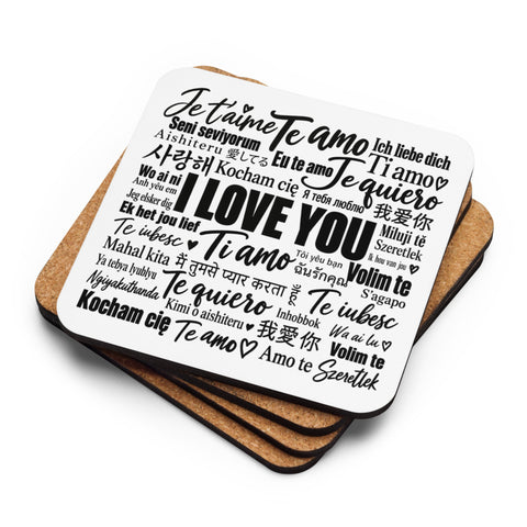 Love in Every Language printed coaster resting on a small stack of cork-back coasters.