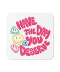 Glossy white cork-back coaster with original pink Have the Day You Deserve lettering and colourful smiley faces centred in full – ZIPZAPPA