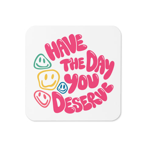 Glossy white cork-back coaster with original pink Have the Day You Deserve lettering and colourful smiley faces centred in full – ZIPZAPPA