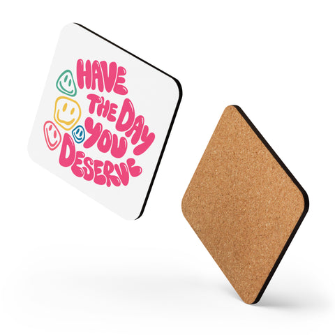 Glossy white cork-back coaster with original pink Have the Day You Deserve lettering and colourful smiley faces centred in full – ZIPZAPPA