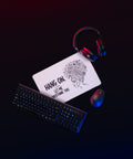 White Overthink This desk mat on a gaming desk beside a mouse and headphones.