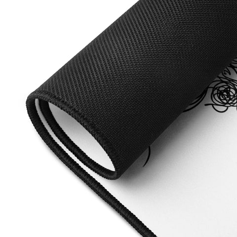 Rolled Overthink This desk mat showing its unprinted black rubber underside.
