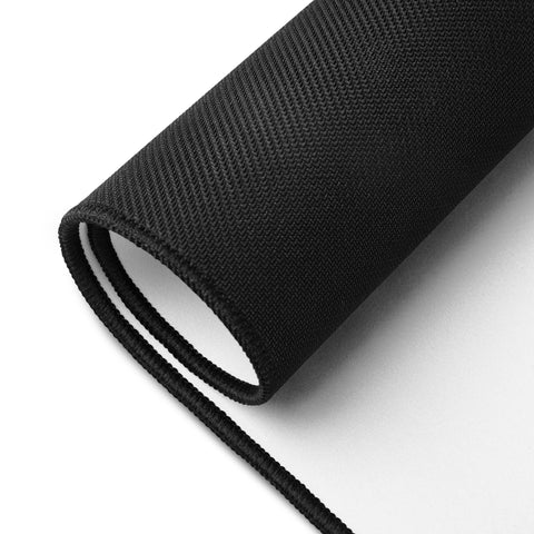 Rolled large Overthink This desk mat showing its unprinted black rubber underside.