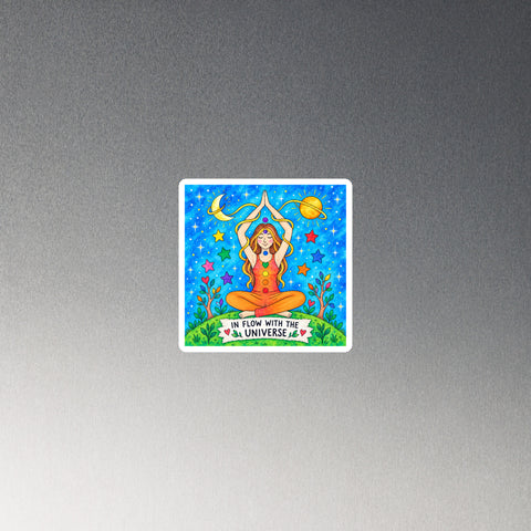 In Flow with the Universe colourful square chakra magnet with seated figure, stars and planets – on black circular metal surface