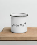 White Travel More, Worry Less enamel camping mug with a silver rim on a wooden tray, showing one complete black travel quote and aeroplane design.