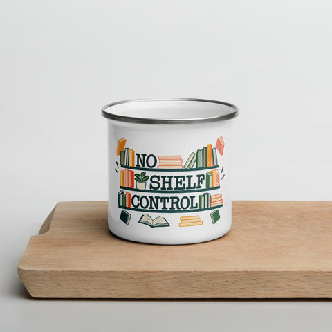 White 12 oz No Shelf Control enamel mug on a wooden board, front view of the colourful books and green lettering.