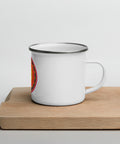 White 12 oz enamel mug with a silver rim and a pink, purple and golden-orange Om mandala on the front, shown on a wooden board; right-side view.