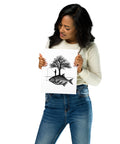 Model holding the Angler’s Island black-and-white matte poster featuring a fisherman, tree and giant fish