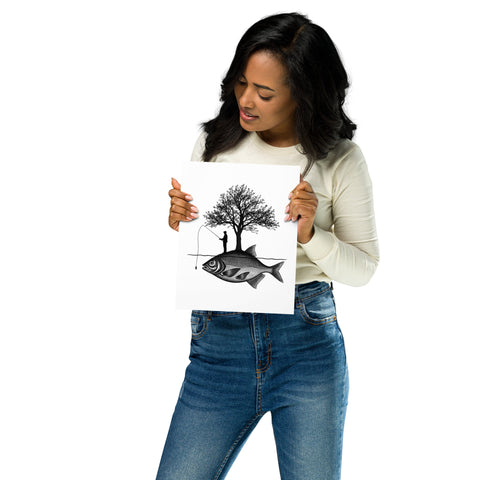 Model holding the Angler’s Island black-and-white matte poster featuring a fisherman, tree and giant fish