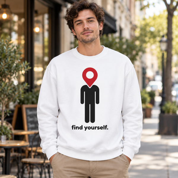 White Find Yourself premium crewneck sweatshirt worn outdoors, with red map pin head, black figure and complete find yourself lettering