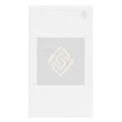 Golden Loop white hand towel with gold-tone geometric emblem on black square – plain white back