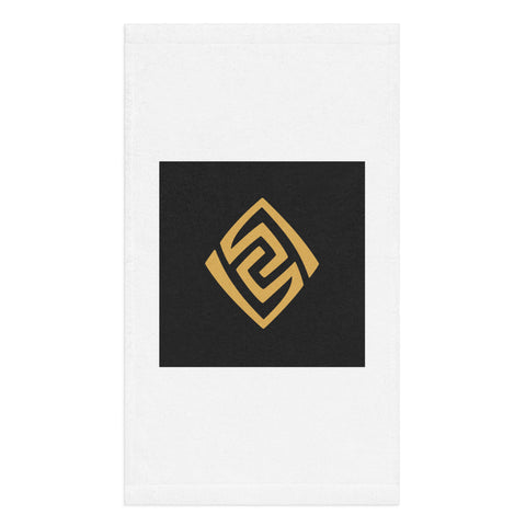 Golden Loop white hand towel with gold-tone geometric emblem on black square – front view