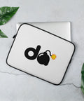 13-inch white D-Bomb Spark laptop sleeve with black trim and black D and cartoon bomb artwork with a yellow-red spark, shown with a laptop and green leaves.
