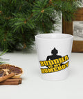 Printed front of a white Buddha Is My Homeboy latte mug beside pastries and green branches.