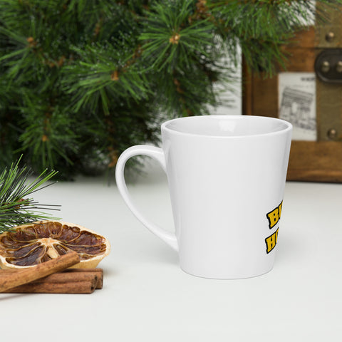 Left-side view of a white Buddha Is My Homeboy latte mug beside pastries and green branches.