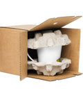 White Buddha Is My Homeboy latte mug protected by moulded packing inserts inside an open cardboard box.