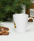 Right-side view of a white Buddha Is My Homeboy latte mug beside pastries and green branches.