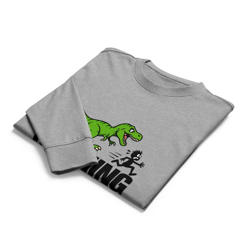 Folded front view of the Carbon Grey Dinosaur Motivation men’s heavyweight long-sleeve tee, showing its single green dinosaur and running quote front print.