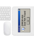 White Error 404 Soul Not Found retro mouse pad on a desk beside a white keyboard and mouse, showing the entire blue-and-grey error dialog design.