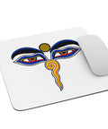 White mouse pad with centred Buddha Wisdom Eyes artwork in blue, red, yellow, orange and black – ZIPZAPPA