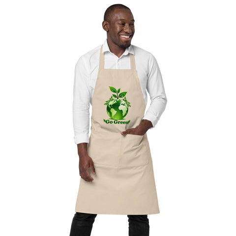 Man wearing a Rope organic cotton apron with green leafy Earth artwork and Go Green lettering above a two-compartment pocket.