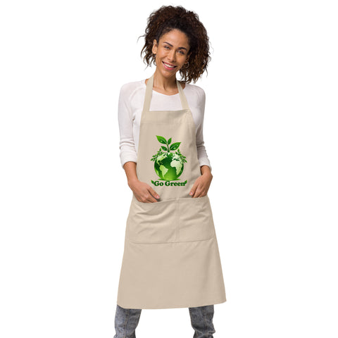 Woman wearing a Rope organic cotton apron with green leafy Earth artwork and Go Green lettering above a two-compartment pocket.