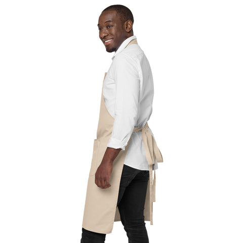 Man wearing a Rope organic cotton apron with green leafy Earth artwork and Go Green lettering above a two-compartment pocket.