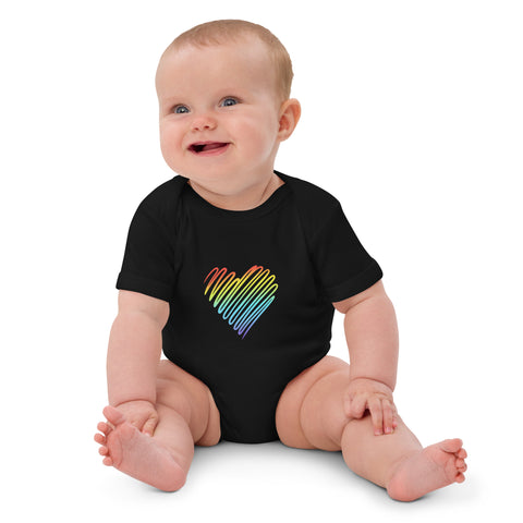 Seated baby wearing the black Rainbow Heart organic cotton bodysuit.
