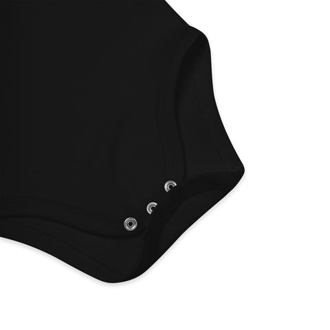 Close-up of the three crotch poppers on the black organic cotton baby bodysuit.
