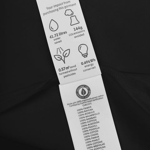 Care label detail on the black Rainbow Heart organic cotton bodysuit.