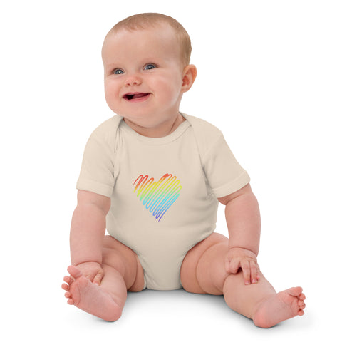 Seated baby wearing the organic natural Rainbow Heart organic cotton bodysuit.