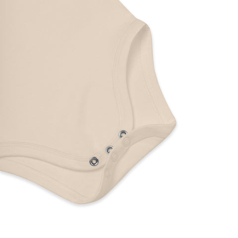 Close-up of the three crotch poppers on the organic natural organic cotton baby bodysuit.