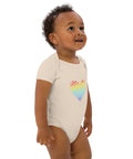 Side view of a baby wearing the organic natural Rainbow Heart organic cotton bodysuit.