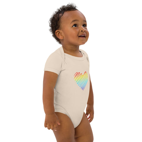 Side view of a baby wearing the organic natural Rainbow Heart organic cotton bodysuit.