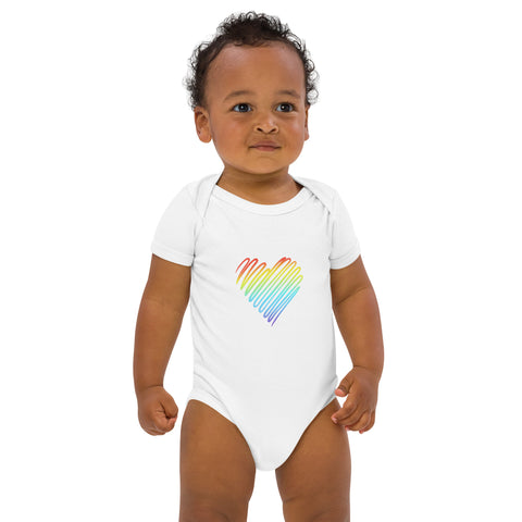 Baby modelling the white Rainbow Heart organic cotton bodysuit, viewed from the front.