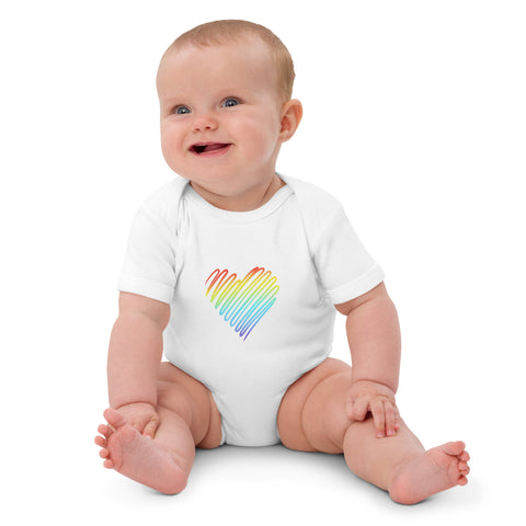 Seated baby wearing the white Rainbow Heart organic cotton bodysuit.