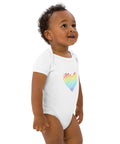 Side view of a baby wearing the white Rainbow Heart organic cotton bodysuit.