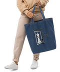 In the Mirror I See Potential organic denim-blue tote bag with large chess pawn and king illustration – front lifestyle view