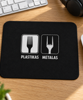 Black Plastikas / Metalas fork humour mouse pad on an oak desk beside a white mouse, keyboard and headphones.