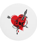 Top view of the white Pierced Skull Heart round mouse pad with one complete red-and-black tattoo-style heart, skull, arrow and dagger design.