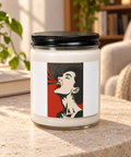 Glass soy candle with a black lid and Scarlet Voice retro portrait label on a stone table in a sunlit living room.