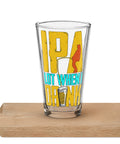 Clear IPA Lot When I Drink shaker pint glass on a wooden tabletop, showing the entire yellow-and-turquoise fishing design with a red angler silhouette and beer illustration.
