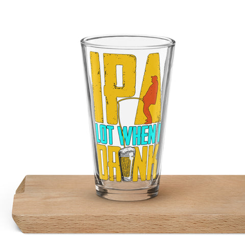 Clear IPA Lot When I Drink shaker pint glass on a wooden tabletop, showing the entire yellow-and-turquoise fishing design with a red angler silhouette and beer illustration.