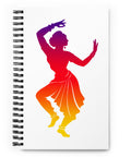 White spiral notebook with a centred classical dancer silhouette in purple, magenta, red, orange and yellow on the front – ZIPZAPPA